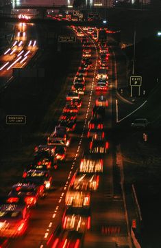 a highway filled with lots of traffic at night