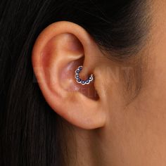 a close up of a person wearing an ear piercing