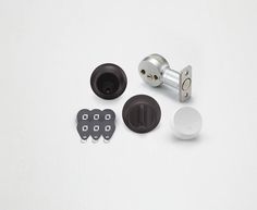 an assortment of door knobs and locks on a white surface