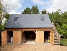 a wooden garage with two doors and windows