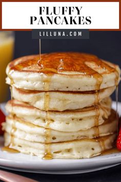 stack of fluffy pancakes with syrup drizzled on top