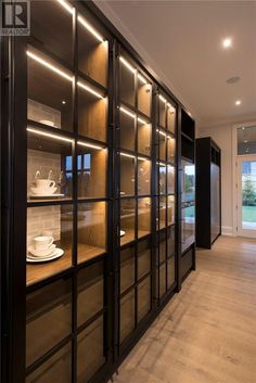 an empty room with glass doors and shelves