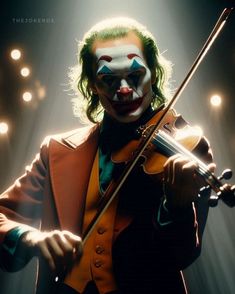 a man in clown makeup holding a violin and looking at the camera with lights behind him