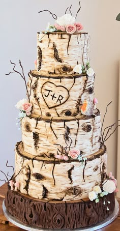 a wedding cake is decorated with flowers and branches