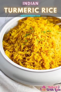 a bowl filled with yellow rice on top of a table