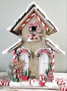 a gingerbread house is decorated with candy canes and decorations for the holiday season