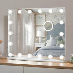 a vanity mirror with lights on top of it