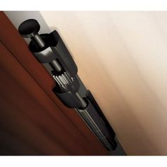 the door handle is attached to the side of a wooden door with two black knobs