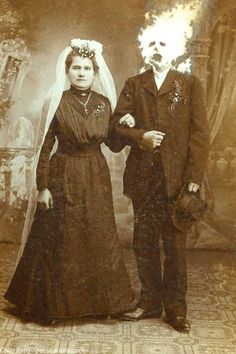 an old photo of a man and woman dressed in wedding attire standing next to each other