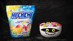 a bag of candy next to a bowl filled with gummy monster eyes and mouth