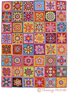 a colorful quilt with many different designs on it's sides and flowers in the middle