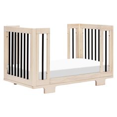 a wooden crib with a mattress in the middle and two sides on each side