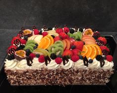 a large cake with fruit on top of it