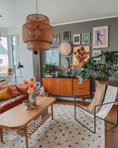 a living room filled with furniture and pictures on the wall