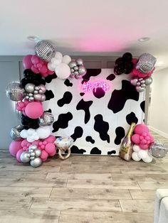 a cow themed birthday party with balloons and decorations