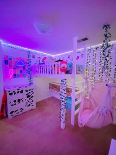 a bedroom decorated in pink and purple lights