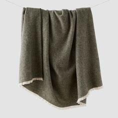 a gray blanket hanging on a clothes line