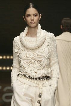 an instagram photo of a model on the catwalk wearing a white sweater and skirt