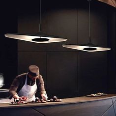 a man standing in front of a counter preparing food