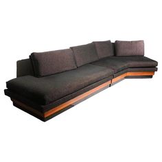 a black couch sitting on top of a wooden table