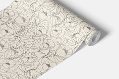 a close up view of a floral pattern on a white wallpaper with black lines