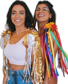 two beautiful women standing next to each other wearing gold and silver decorations on their arms