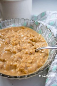 a glass bowl filled with oatmeal next to a cup