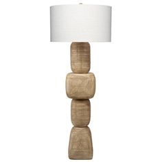 a wooden lamp with a white shade on the top and two stacked blocks below it