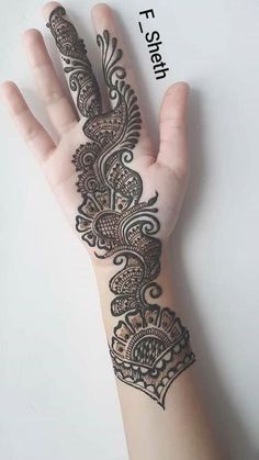 a hand with henna tattoos on it and the word fish written in black ink