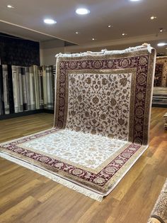 a large rug is on display in the middle of a room