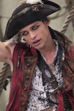 a man dressed in pirate costume posing for the camera