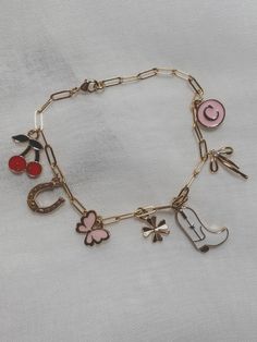 a gold bracelet with charms on it