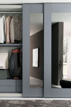 an open closet with clothes on the shelves