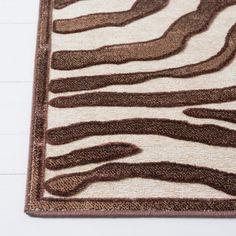 a brown and white rug with zebra stripes