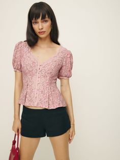 Up top. Shop the Minette Top from Reformation, a fitted top with a v-neckline, button front, short puffed sleeves, and lace detailing. Feminine Fitted V-neck Puff Sleeve Top, Feminine V-neck Tops With Button Closure, Feminine V-neck Top With Button Closure, Fitted V-neck Puff Sleeve Top, Fitted V-neck Puff Sleeve Top For Daywear, Feminine V-neck Fitted Puff Sleeve Top, Feminine Fitted V-neck Blouse, Spring Fitted V-neck Puff Sleeve Top, Fitted Feminine Puff Sleeve V-neck Top