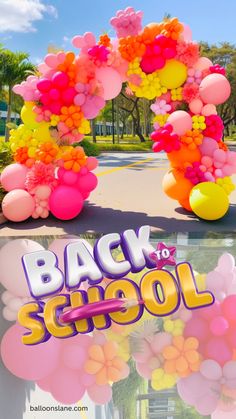 the back to school sign is decorated with balloons