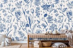 a blue and white floral wallpaper in a room with wooden flooring next to a bench