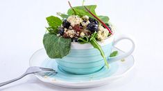 a cup filled with food sitting on top of a saucer