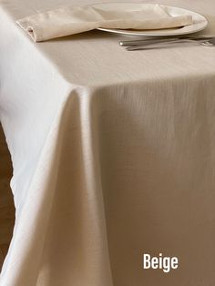 a table with a white cloth and silverware on it