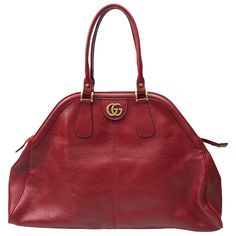 Gucci Red Marmont Re(Belle) Handbag. This beautiful Gucci handbag is in excellent condition. It has no sign of use and has the care card with a color swatch in the pocket. It is a large bag with a deep red leather material. There is gold hardware with a gold "GG" on one side and a gold Tiger head on the other side. It has a gold zipper going across the top with two top handles. This piece is the perfect addition to any summer outfit and has plenty of room on the inside for storage of items. Meas Chic Gucci Satchel With Removable Pouch, Everyday Handheld Gucci Satchel, Gucci Formal Bags With Double Handle, Formal Gucci Bag With Double Handle, Gucci Formal Satchel With Removable Pouch, Gucci Satchel With Removable Pouch For Formal Occasions, Gucci Formal Satchel Bag, Chic Handheld Gucci Bag, Gucci Tote Shoulder Bag For Formal Occasions