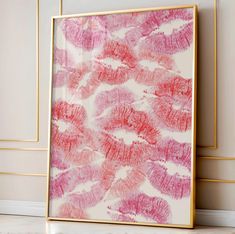 a pink and red painting on the wall next to a white floor with gold frame