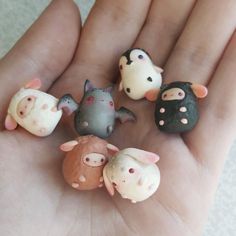 small toy animals are sitting in the palm of someone's hand