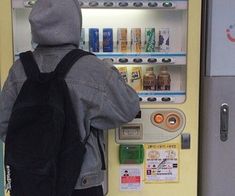 a person standing in front of a vending machine