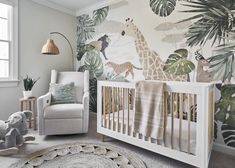 a baby's room with a giraffe wallpaper and a rocking chair