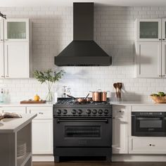 a stove top oven sitting inside of a kitchen next to an oven and countertop