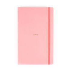 a pink notebook with gold lettering on the front and bottom, sitting against a white background