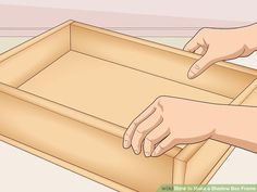 a person reaching into a wooden box with their hand on the lid and another hand pointing at it