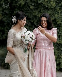 two women standing next to each other in dresses