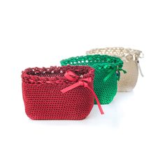 three crocheted baskets with red, green and white handles