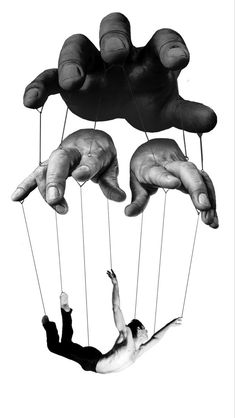 two hands are suspended by strings over a man's body in black and white